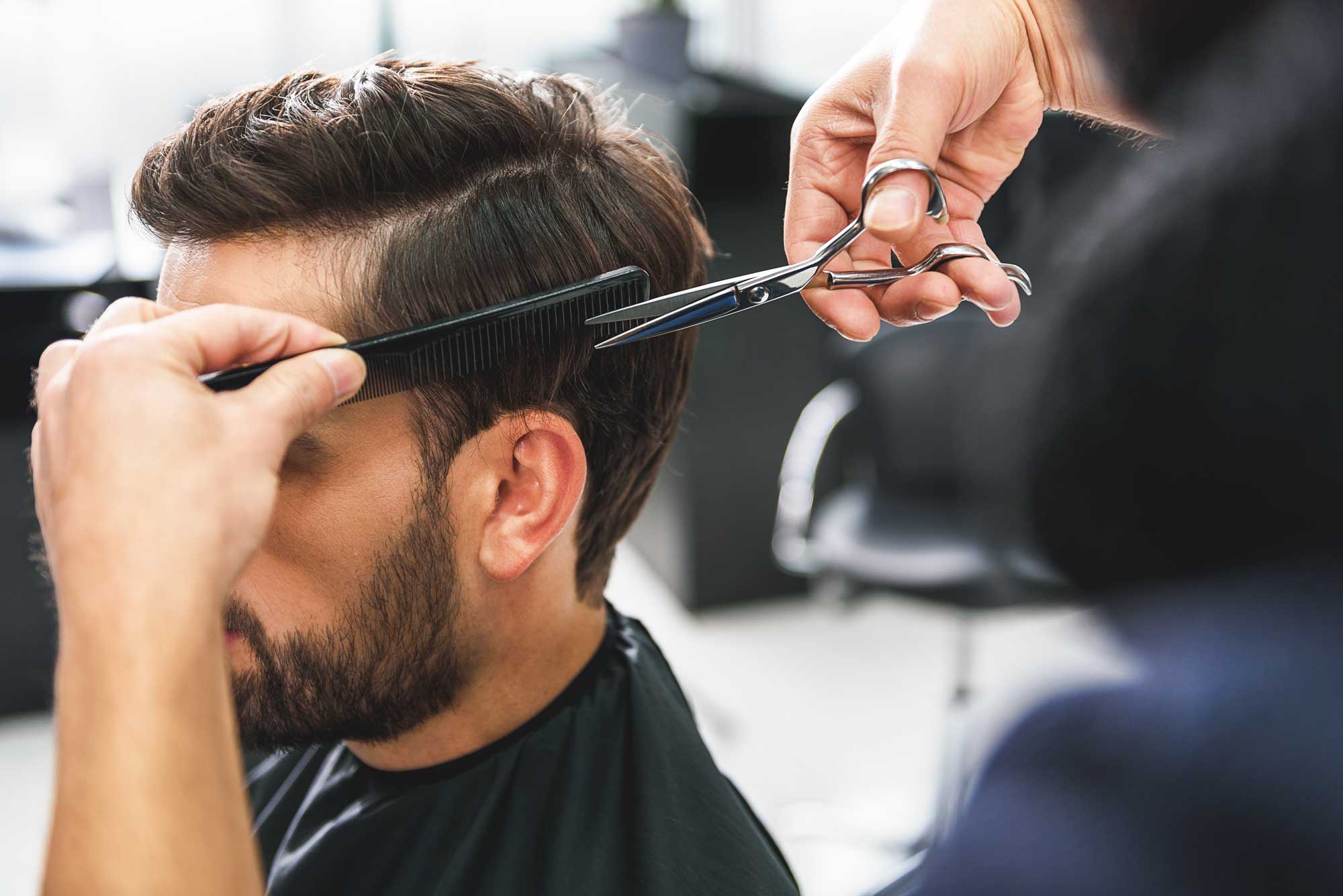 A man getting a hair cut at the salon